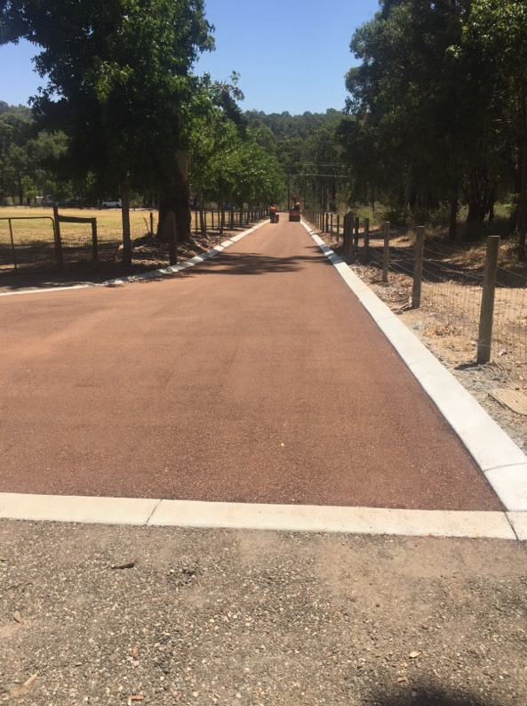 This is a photo of a hot spray & seal bitumen roadway which is in the process of being installed by Sunbury Road Tech